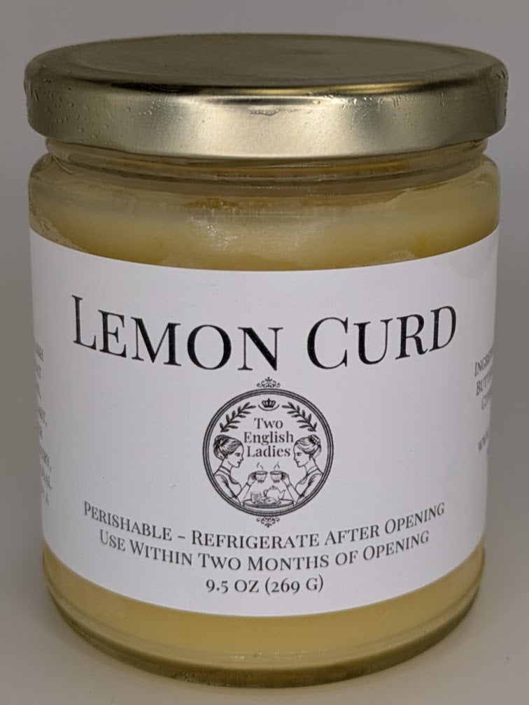 Jar of lemon curd with a gold lid on a white background