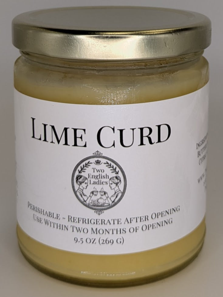 Jar of lime curd with a gold lid on a white background
