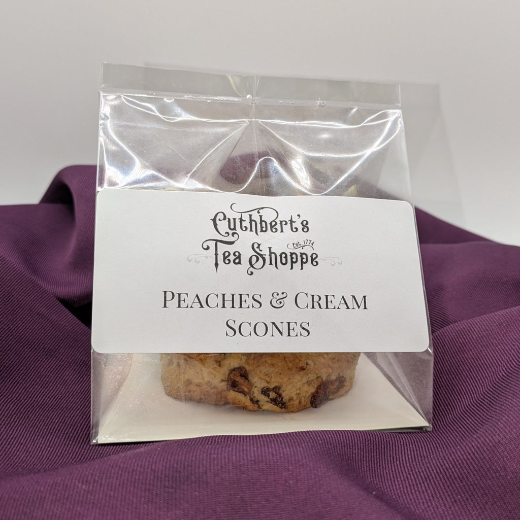 A package of peaches and cream scones sitting on purple fabric