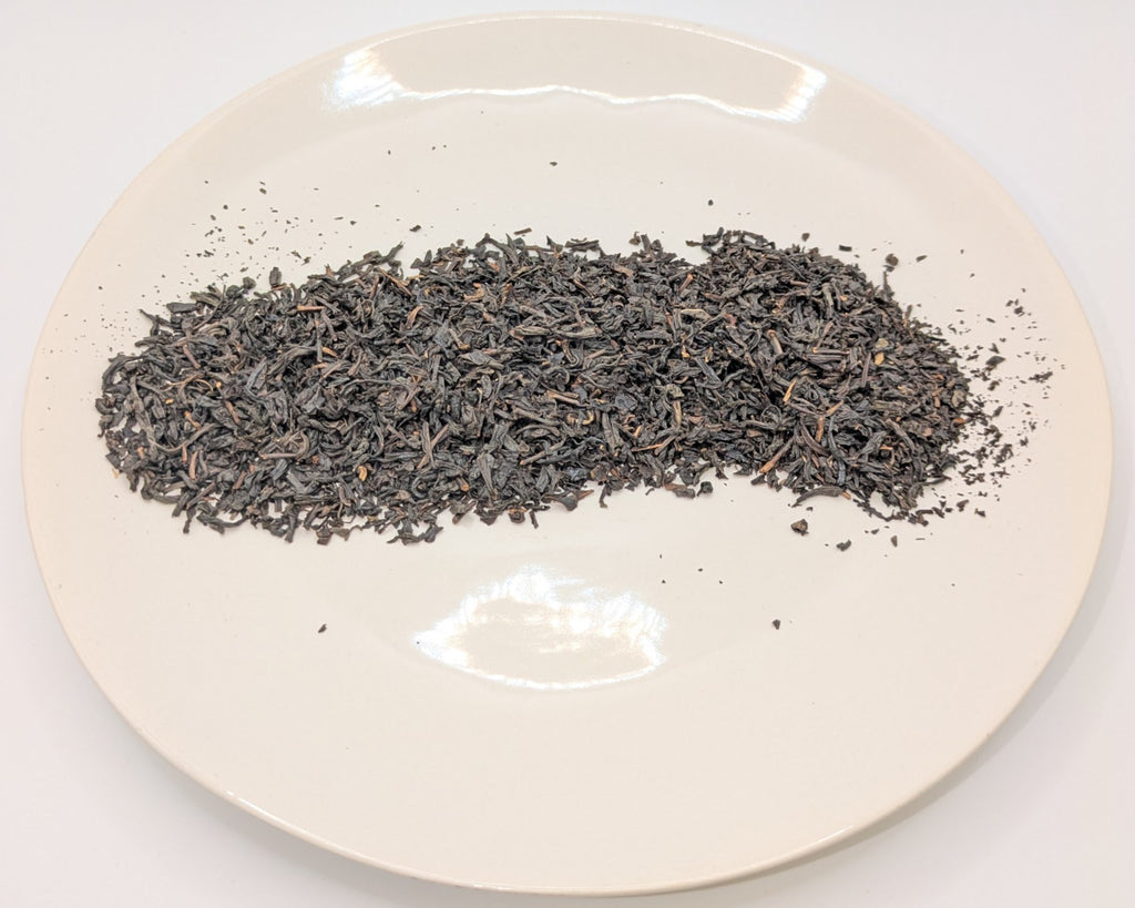 A scoop of earl grey tea on a white plate