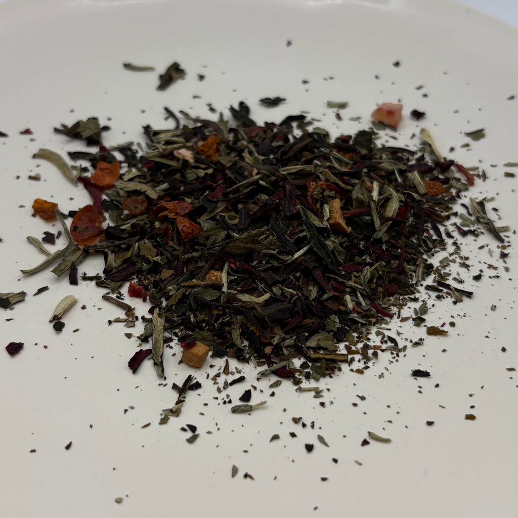 A scoop of Edwina's Peaches tea on a white background