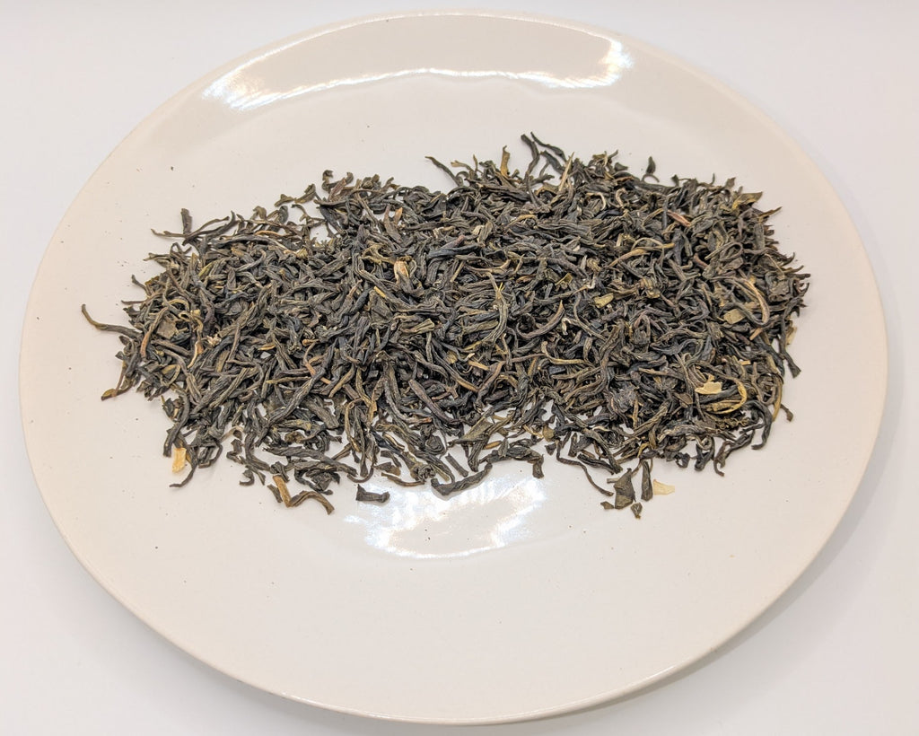 A scoop of Jade Garden tea on a white plate