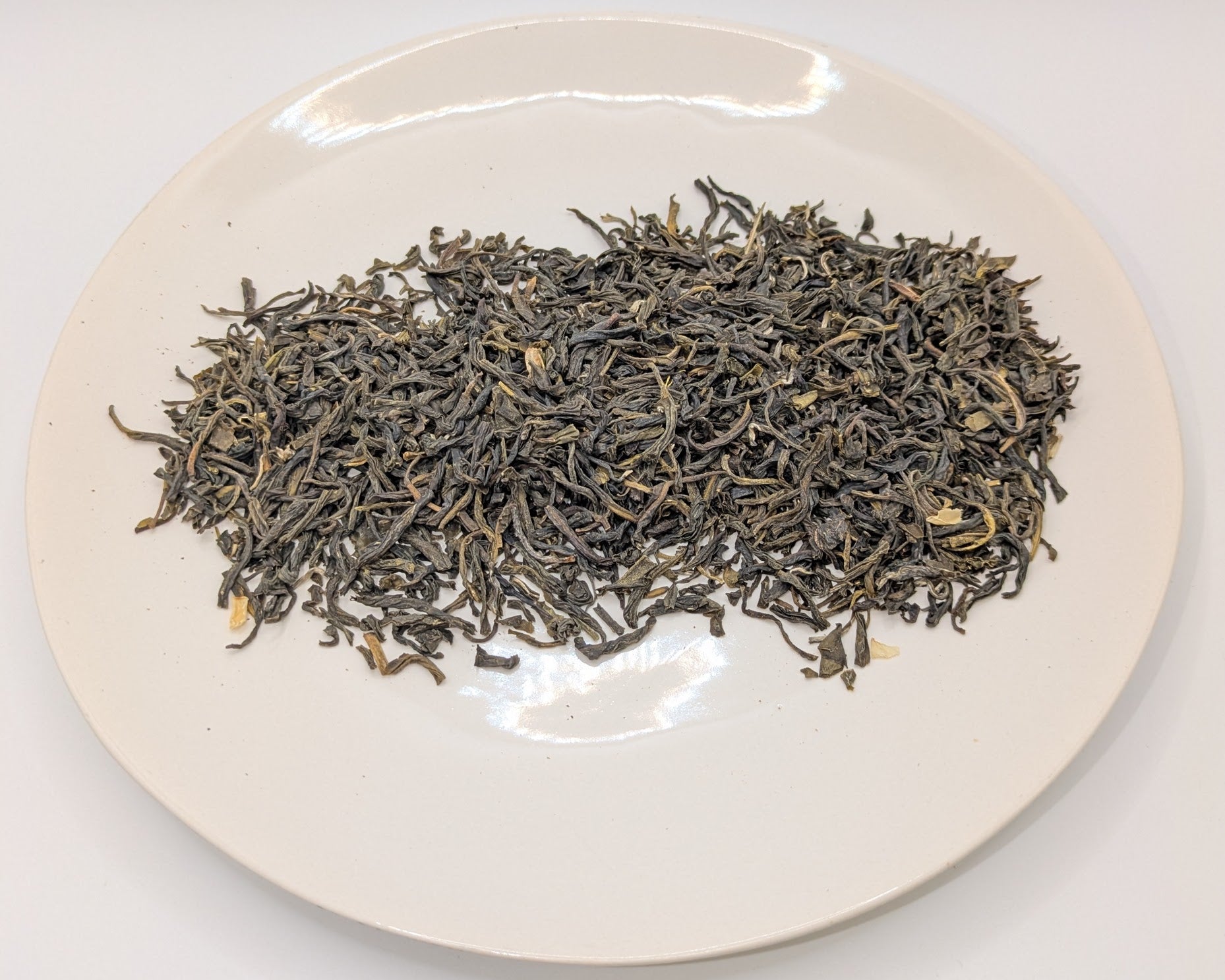 A scoop of Jade Garden tea on a white plate