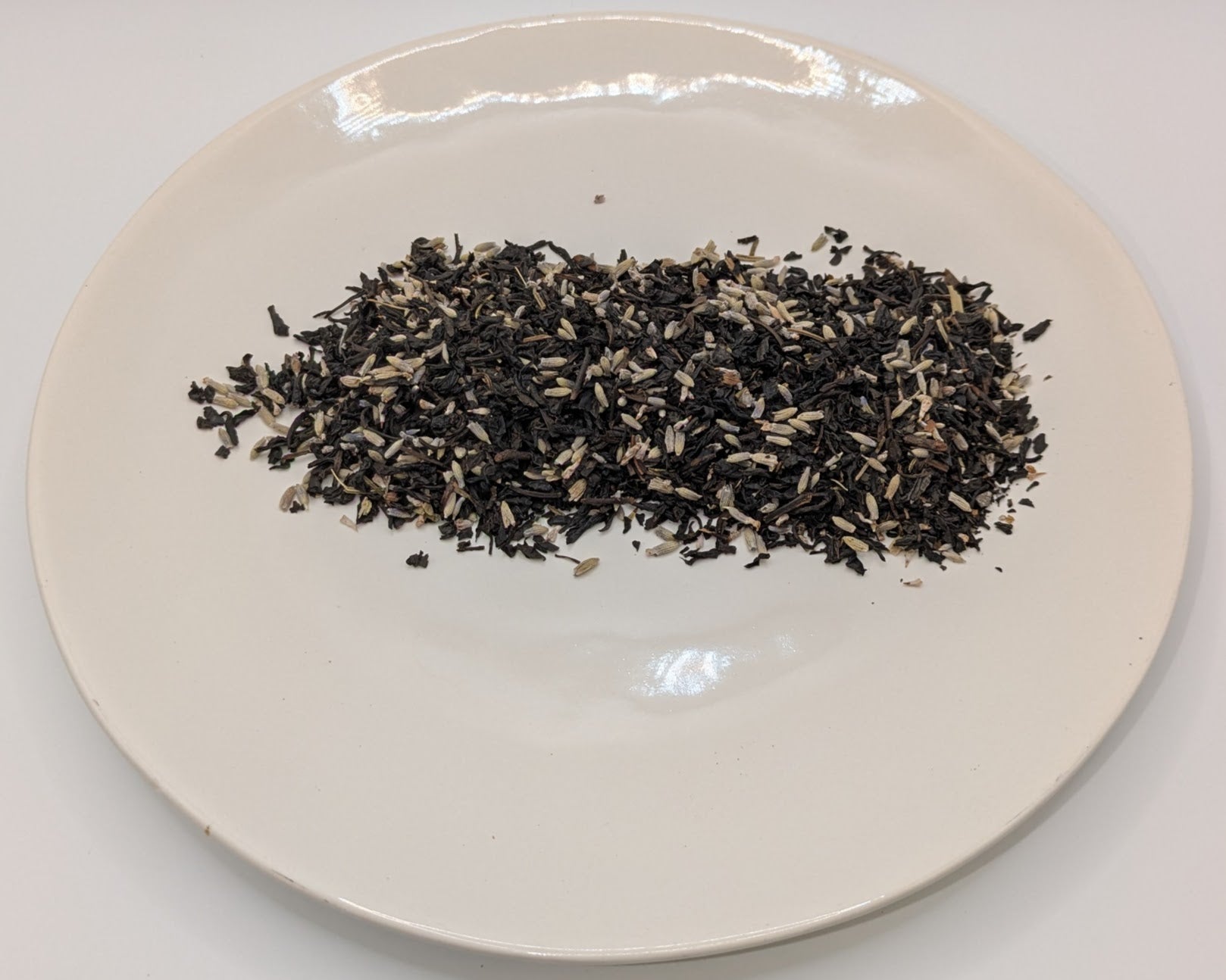A scoop of lavender grey tea on a white plate