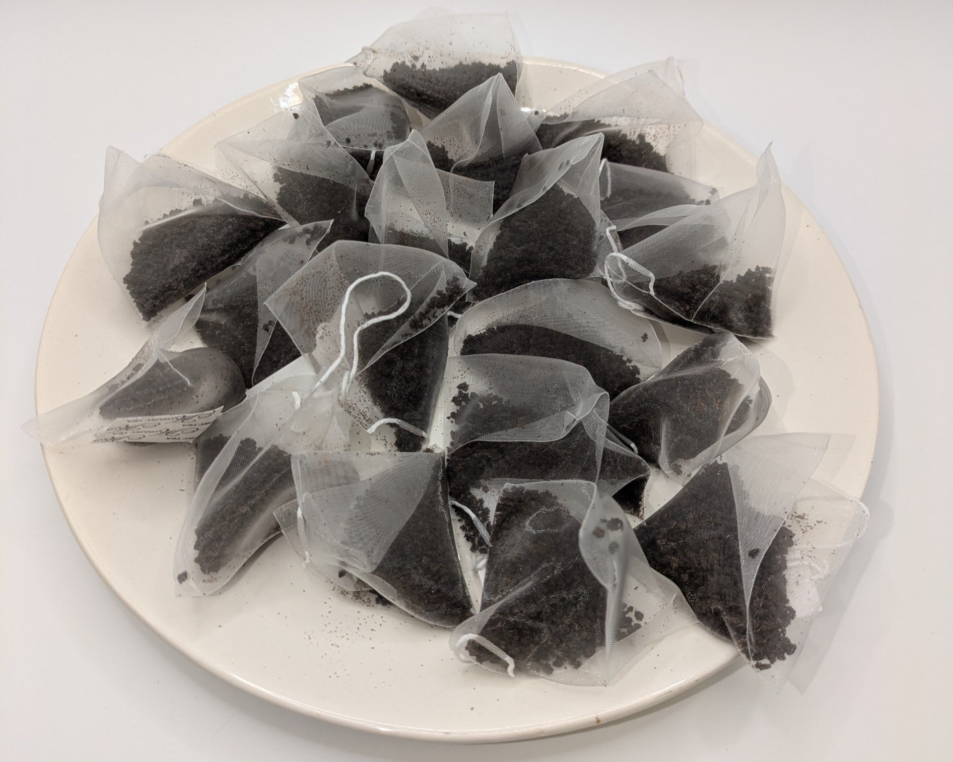 A pile of bagged Irish breakfast tea on a white plate